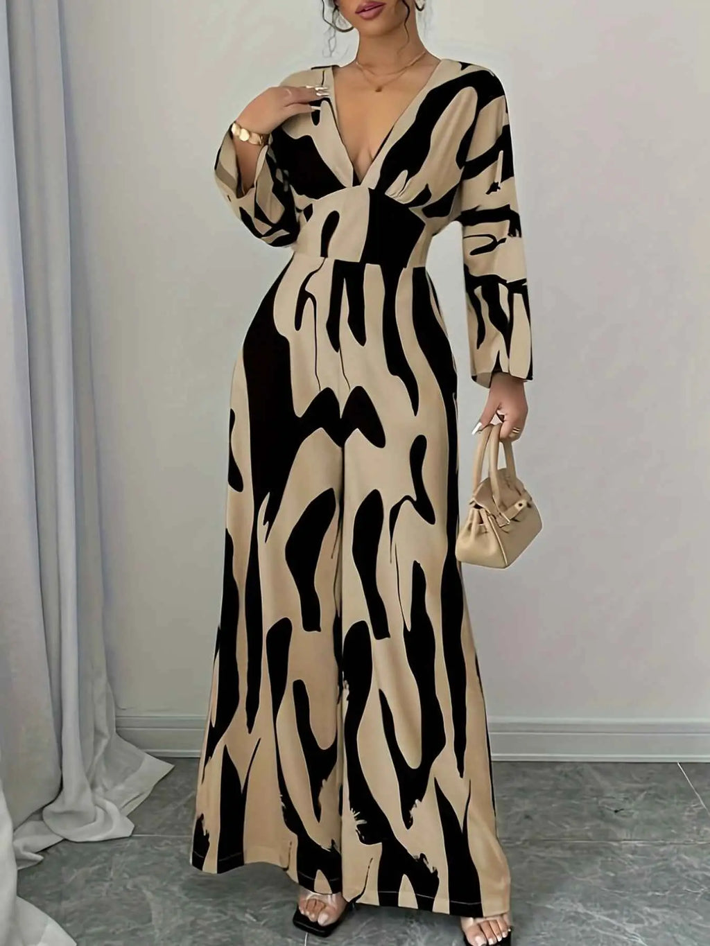 Abstract Print V-Neck wide leg jumpsuit in beige and black with a belted waist and long sleeves