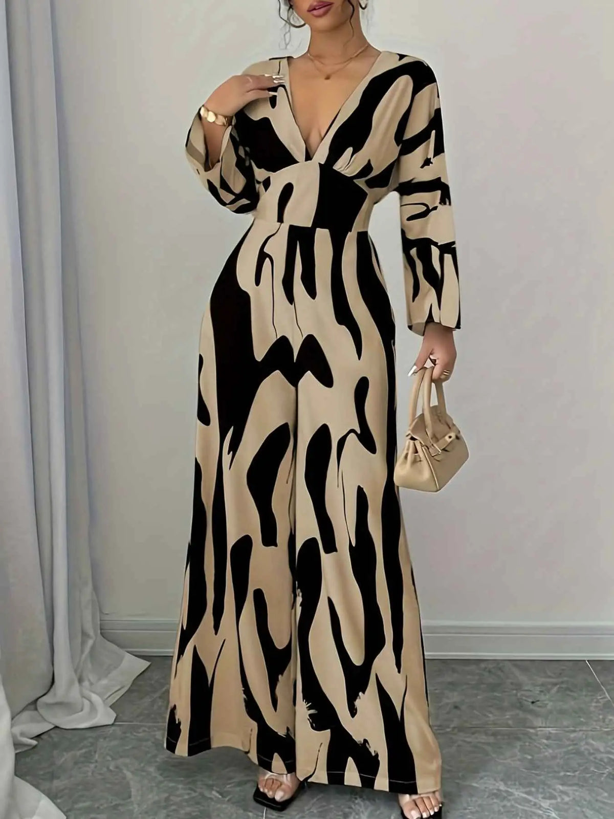 Abstract Print V-Neck wide leg jumpsuit in beige and black with a belted waist and long sleeves