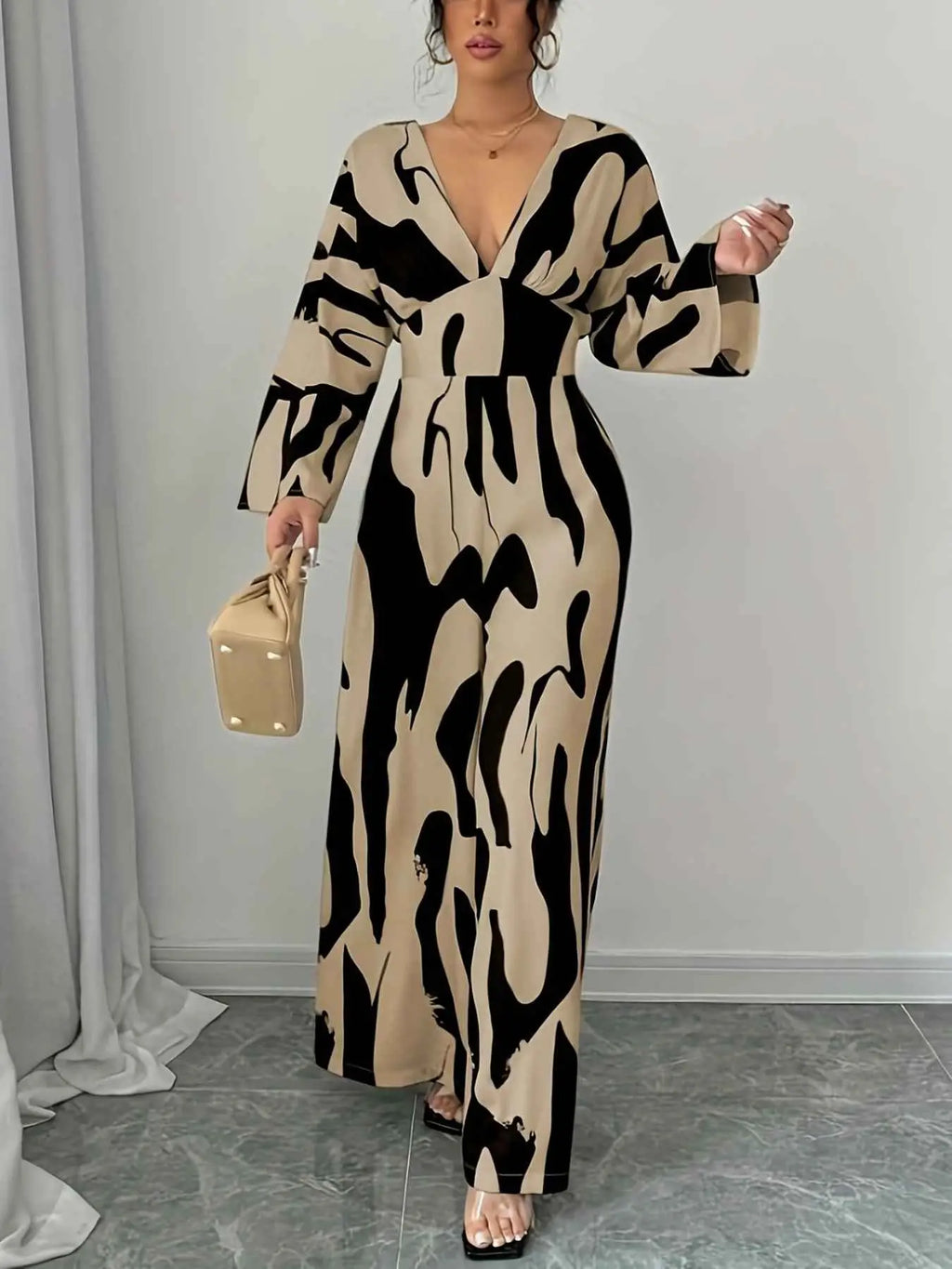 Abstract Print V-Neck wide leg jumpsuit in beige and black with long sleeves and belted waist detail