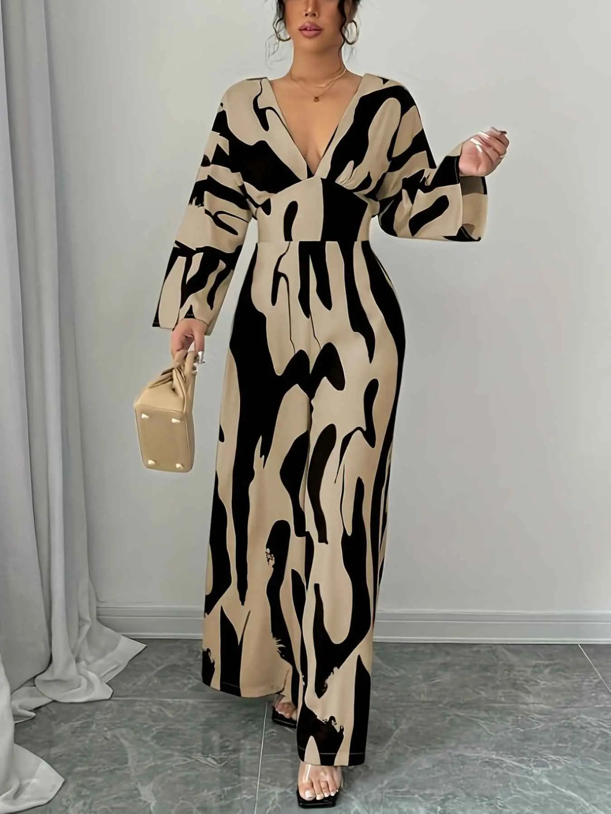 Abstract Print V-Neck wide leg jumpsuit in beige and black with long sleeves and belted waist detail
