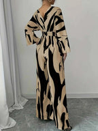 Abstract Print V-Neck wide leg jumpsuit in beige and black with abstract pattern, belted waist, long sleeves, deep V neckline