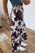 Abstract Print Western long skirt with a black and white cowhide pattern, fitted waist, metal zip closure, and decorative belt detail