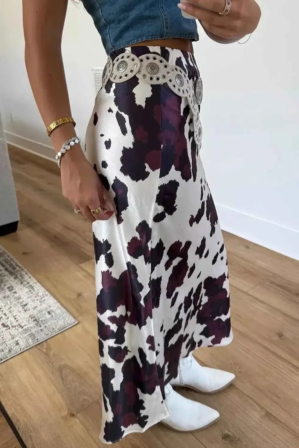 Abstract Print Western long skirt with a black and white cowhide pattern, fitted waist, metal zip closure, and decorative belt detail