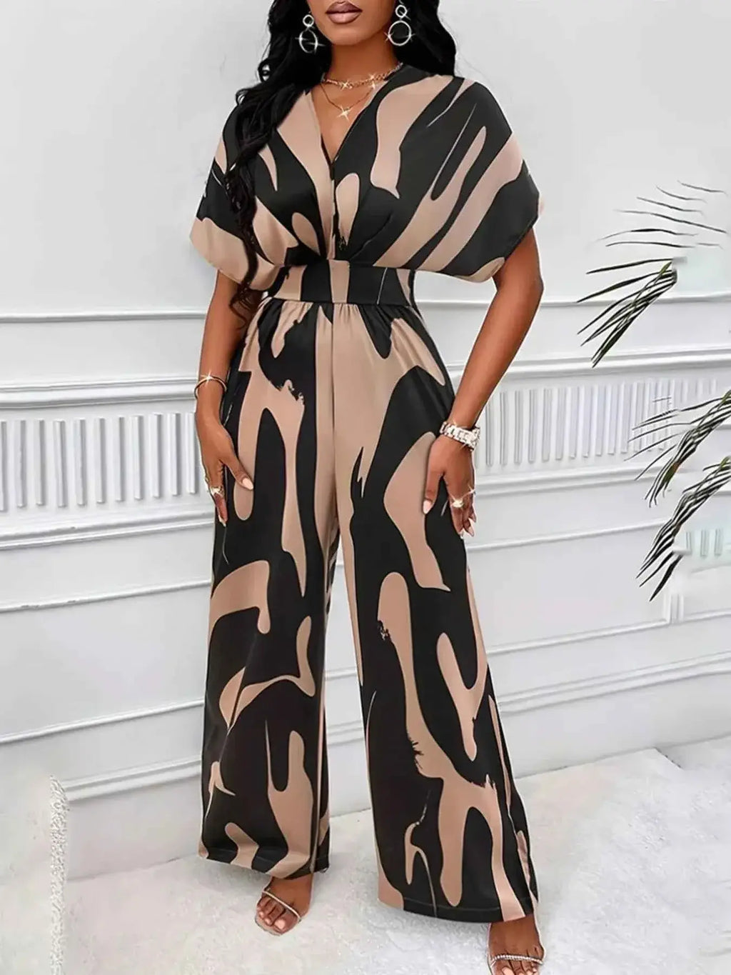 Abstract Print Wide-Leg Jumpsuit featuring a beige and black abstract pattern with ruched waist and wide legs on polyester fabric