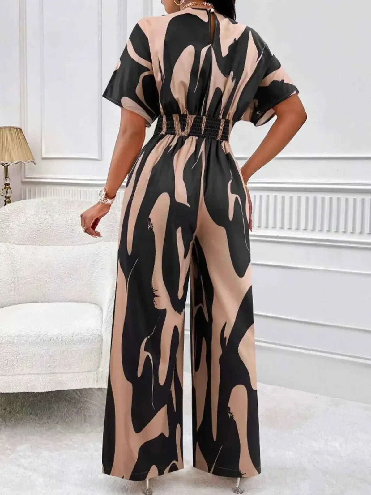 Abstract Print Wide-Leg Jumpsuit in beige and black with ruched waist and short sleeves made from 100% polyester