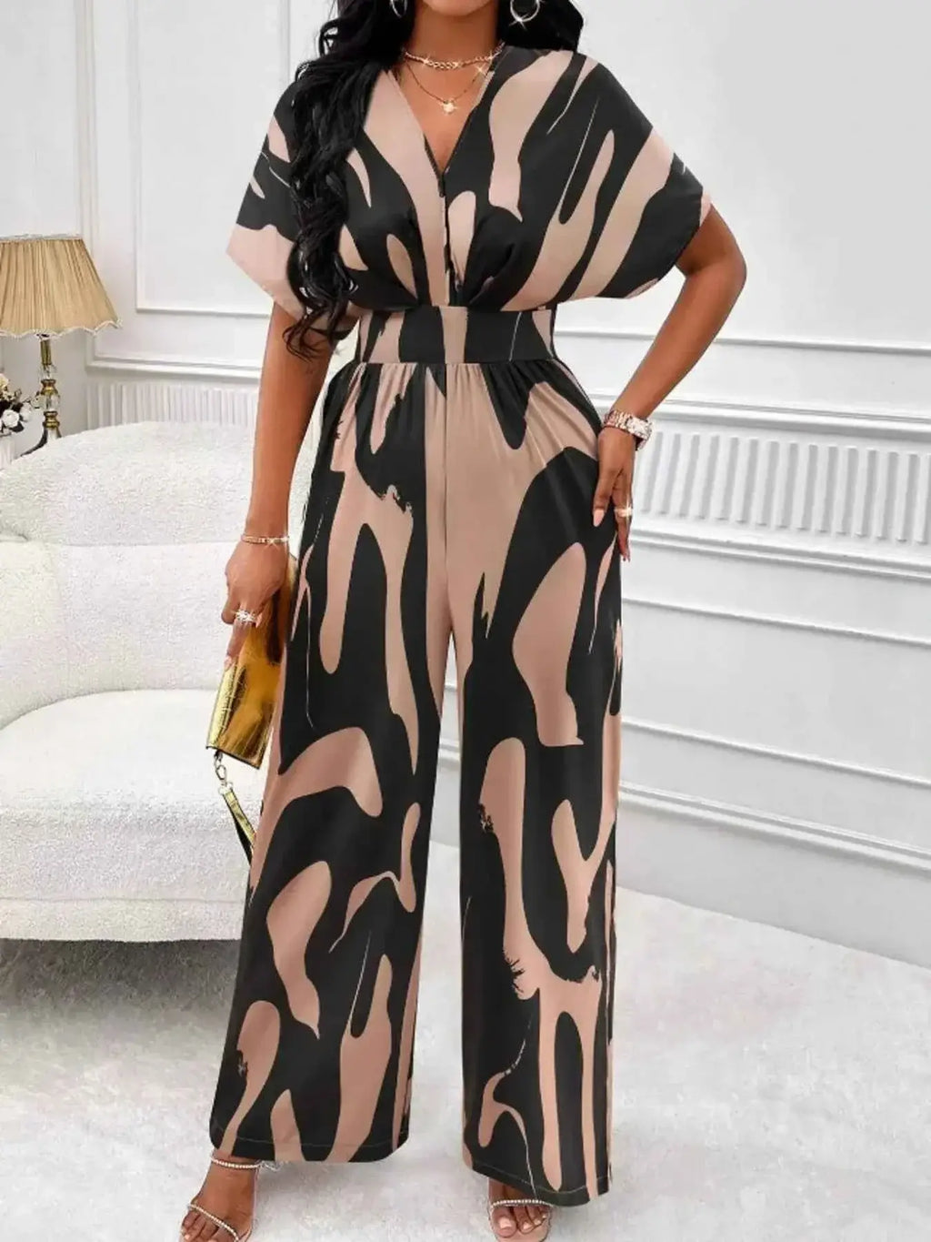 Abstract Print Wide-Leg Jumpsuit featuring large black and beige abstract patterns with ruched waist and wide leg fit