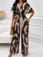 Abstract Print Wide-Leg Jumpsuit featuring large black and beige abstract patterns with ruched waist and wide leg fit