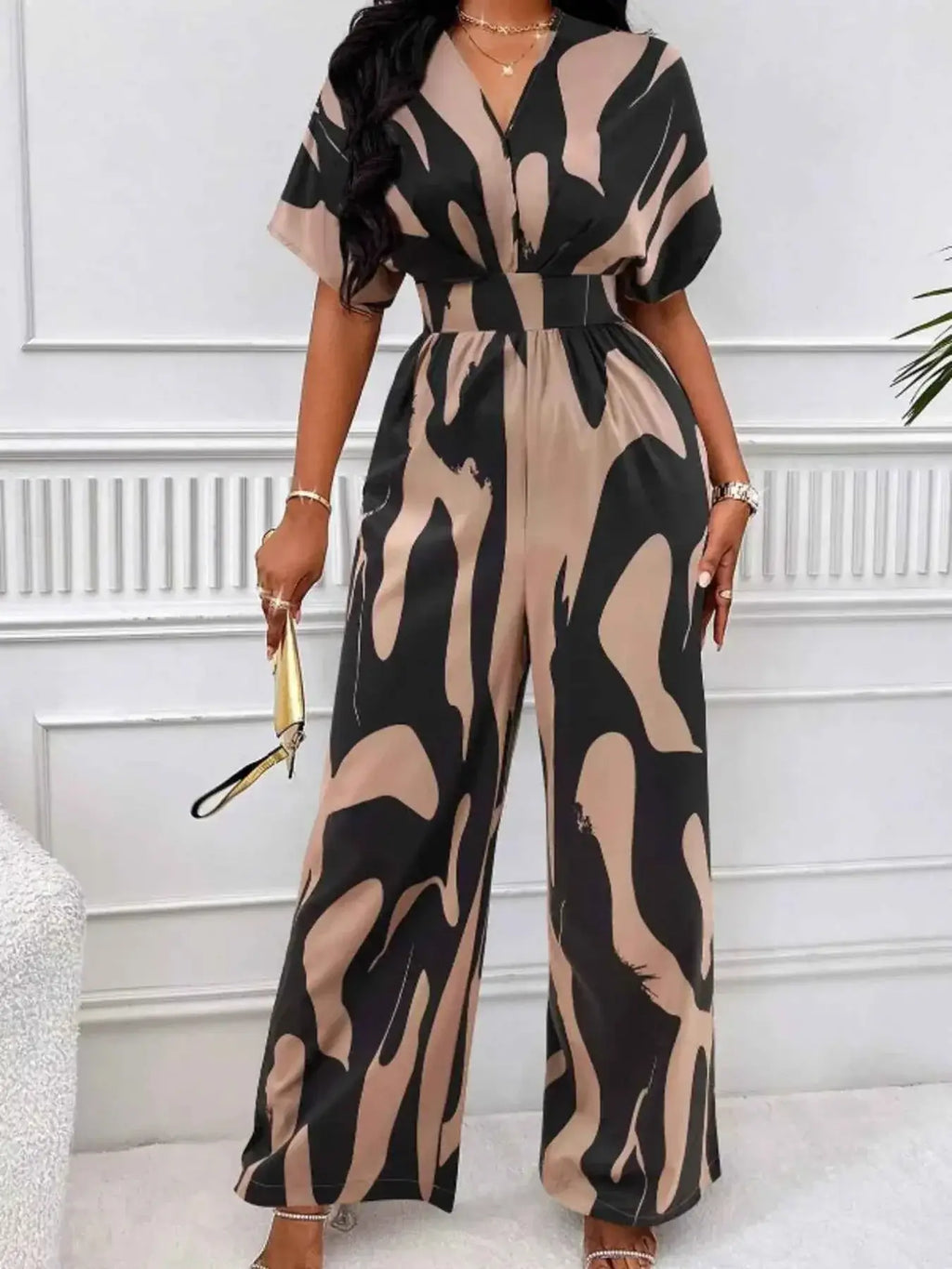 Abstract Print Wide-Leg Jumpsuit in black and beige with ruched waist, short sleeves, and bold abstract pattern