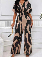 Abstract Print Wide-Leg Jumpsuit in black and beige with ruched waist, short sleeves, and bold abstract pattern