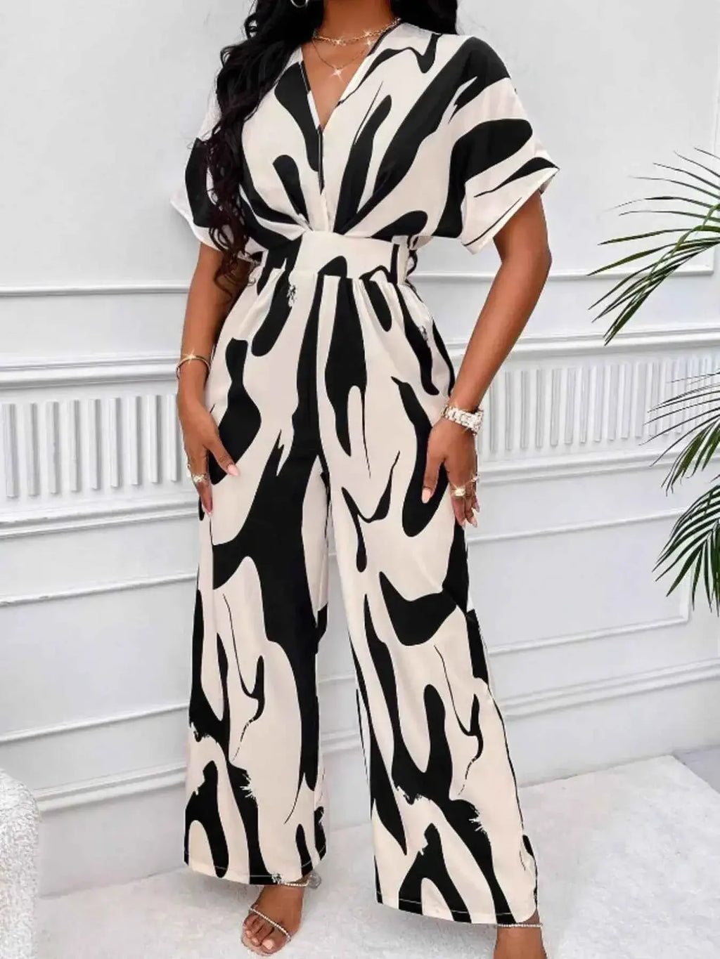 Abstract Print Wide-Leg Jumpsuit in black and beige polyester with ruched waist and short sleeves, wide-leg silhouette