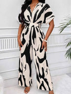 Abstract Print Wide-Leg Jumpsuit in black and beige polyester with ruched waist and short sleeves, wide-leg silhouette