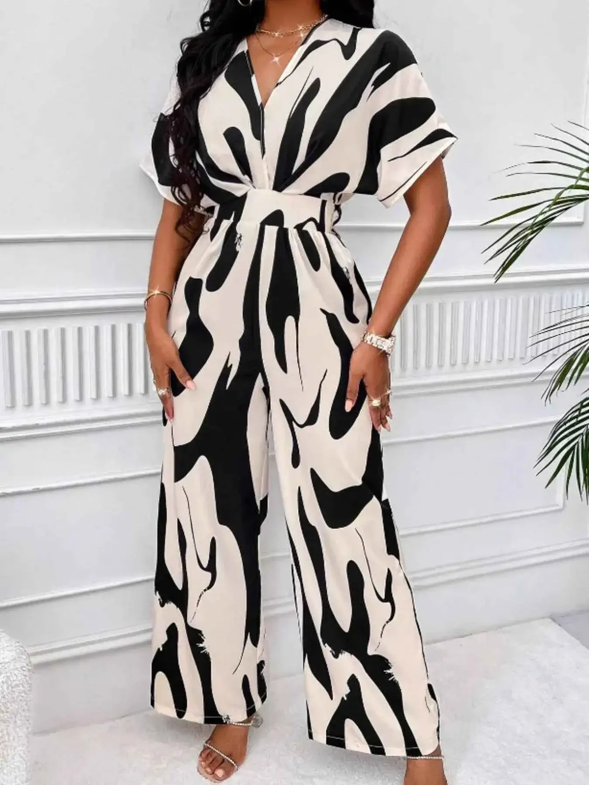 Abstract Print Wide-Leg Jumpsuit in black and beige polyester with ruched waist and short sleeves, wide-leg silhouette