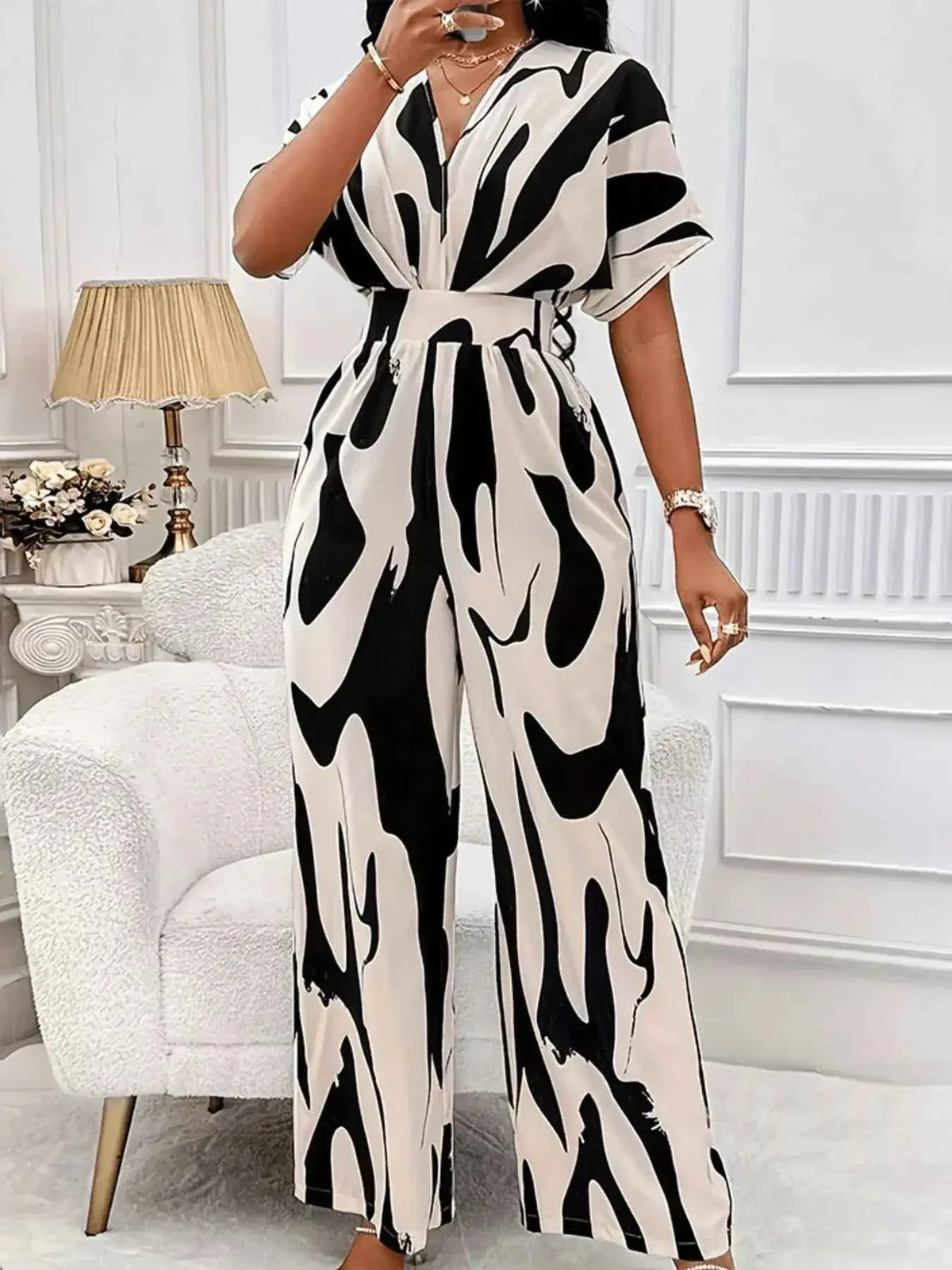 Abstract Print Wide-Leg Jumpsuit in black and white with ruched detailing and short sleeves, made of smooth polyester fabric