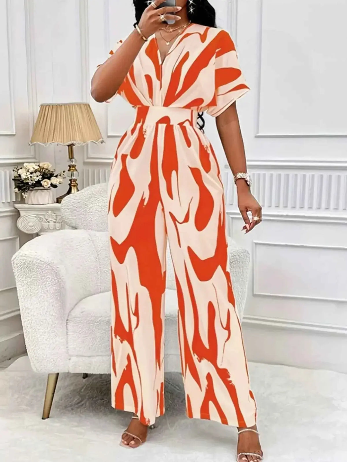 Abstract Print Wide-Leg Jumpsuit in cream and vibrant orange with ruched waist and short sleeves made of polyester