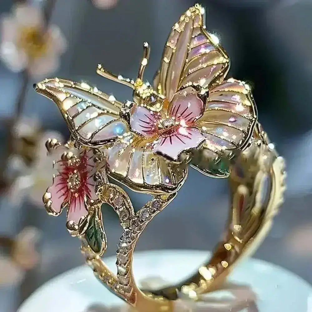 Aesthetic Flower Butterfly Rings featuring gold-tone metal with pink flower and butterfly designs accented by rhinestones