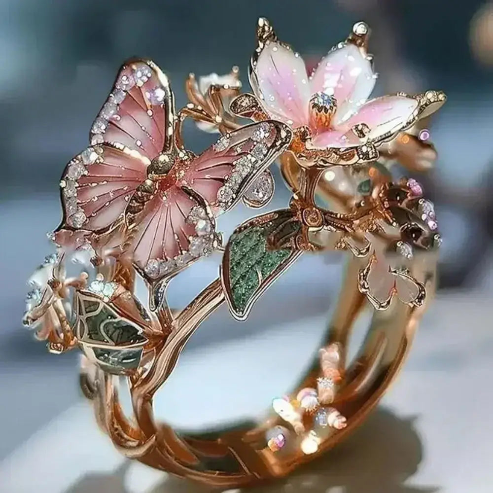 Aesthetic Flower Butterfly Rings featuring a gold-tone metal band with pink butterfly wings, white flower petals, green leaves, and small rhinestones