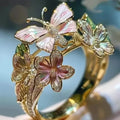 Golden metal Aesthetic Flower Butterfly Rings featuring pink and white enamel butterflies and flowers with rhinestone accents