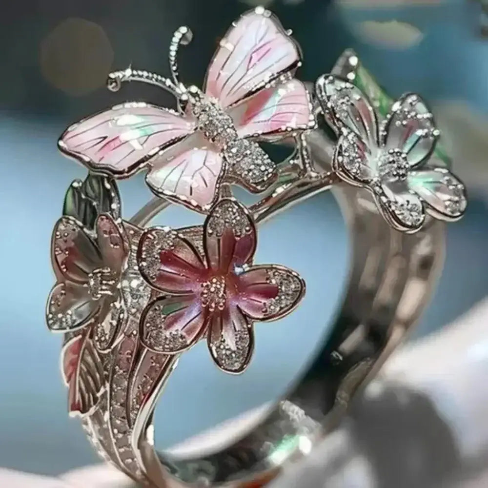 Silver-tone Aesthetic Flower Butterfly Rings featuring pink enamel butterfly and flower designs with rhinestone accents and an adjustable band