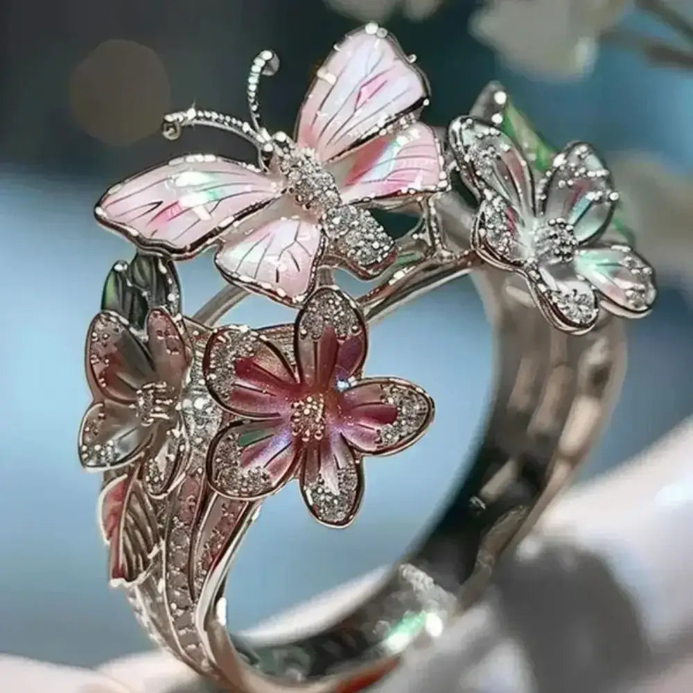 Silver metal Aesthetic Flower Butterfly Rings featuring pink enamel butterfly and flower shapes with rhinestone accents