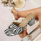 Animal Print block heel sandals with black and white zebra stripe pattern, open toe and mid heel design