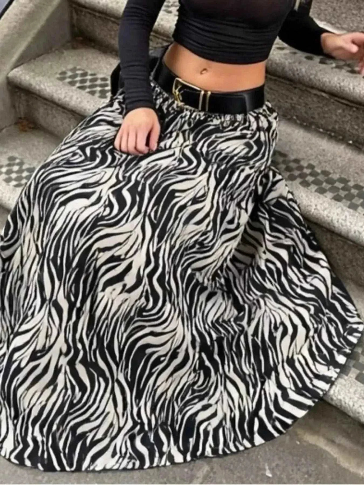 Animal Print Maxi Skirt in black and white zebra pattern with flowy polyester fabric and a black belt