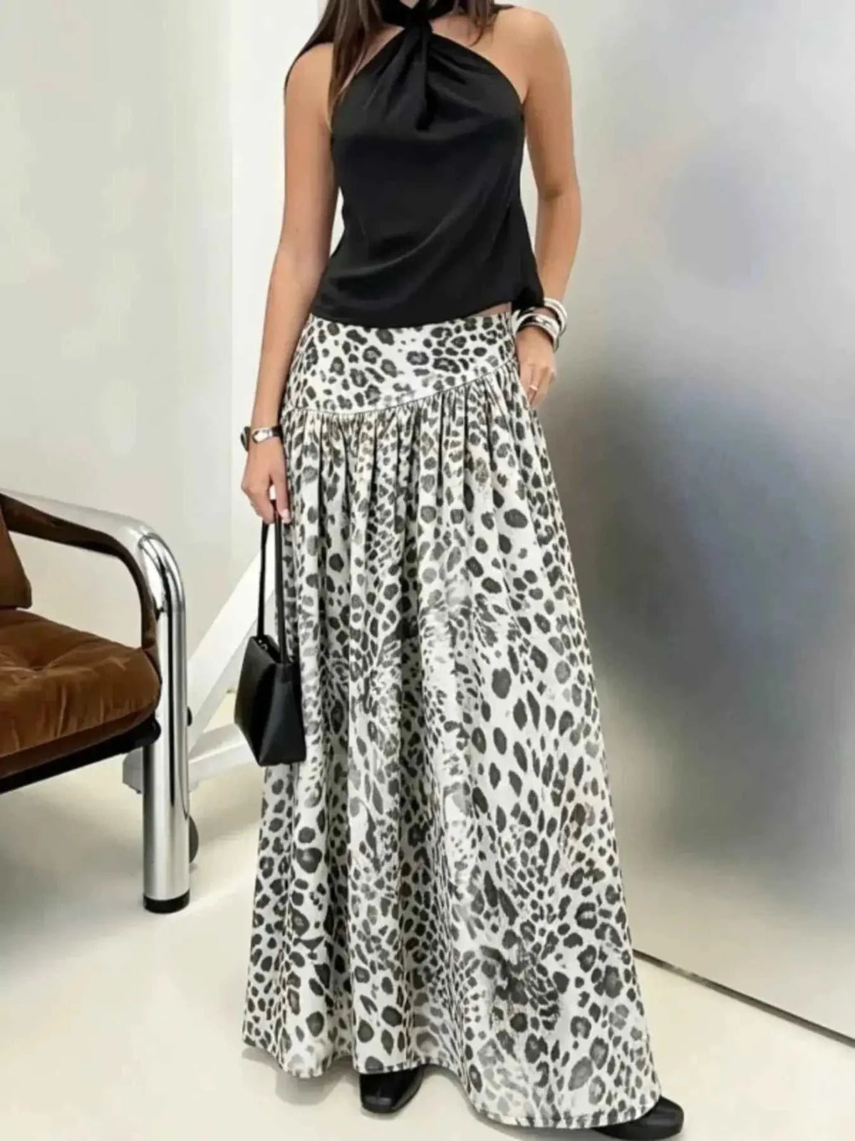 Animal Print Maxi Skirt in white and black leopard pattern, maxi length, flowy polyester fabric worn with a black halter top