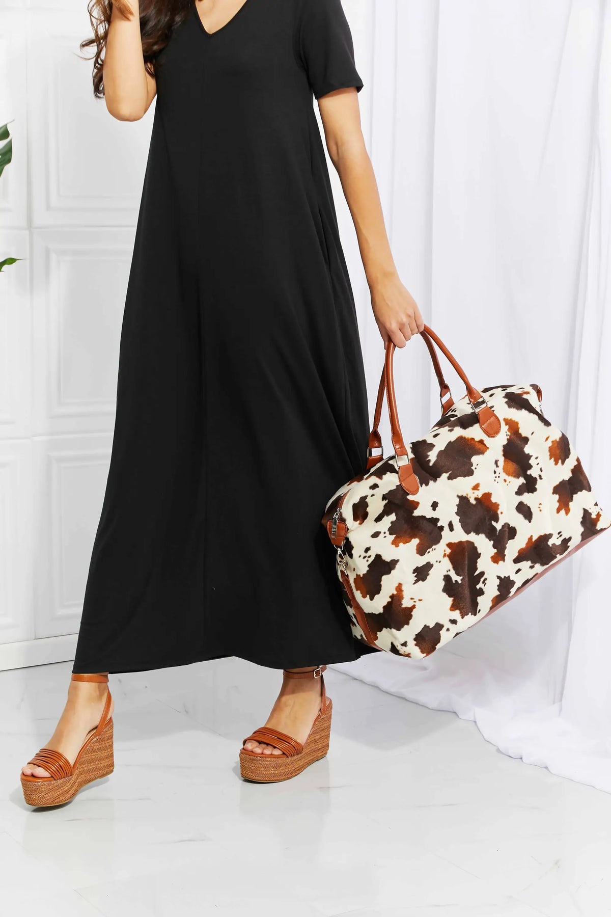 Animal Print Plush medium hand bag with brown and white leopard pattern and top handle straps made of fluff material