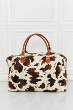 Animal Print Plush medium hand bag with brown and white cow pattern, fluffy material, and brown top handles