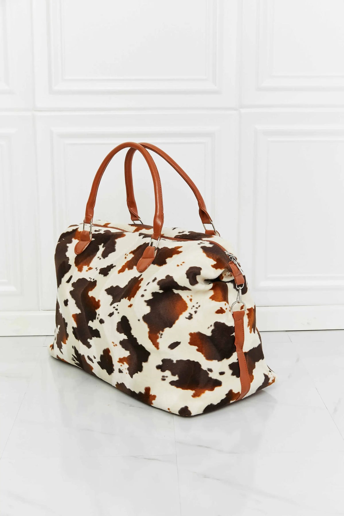 Animal Print Plush medium size weekender bag with brown and white leopard pattern and tan top handles made of fluff material