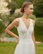 Beach Wedding Dress featuring white lace sleeveless bodice with scalloped V-neckline and smooth flowing skirt