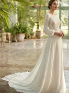 Beach Wedding Dress with long lace sleeves, round neckline, and flowing court train in lightweight white fabric