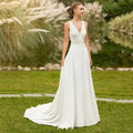 Beach Wedding Dress white boho gown with lace bodice, V-neckline, and flowing court train on model