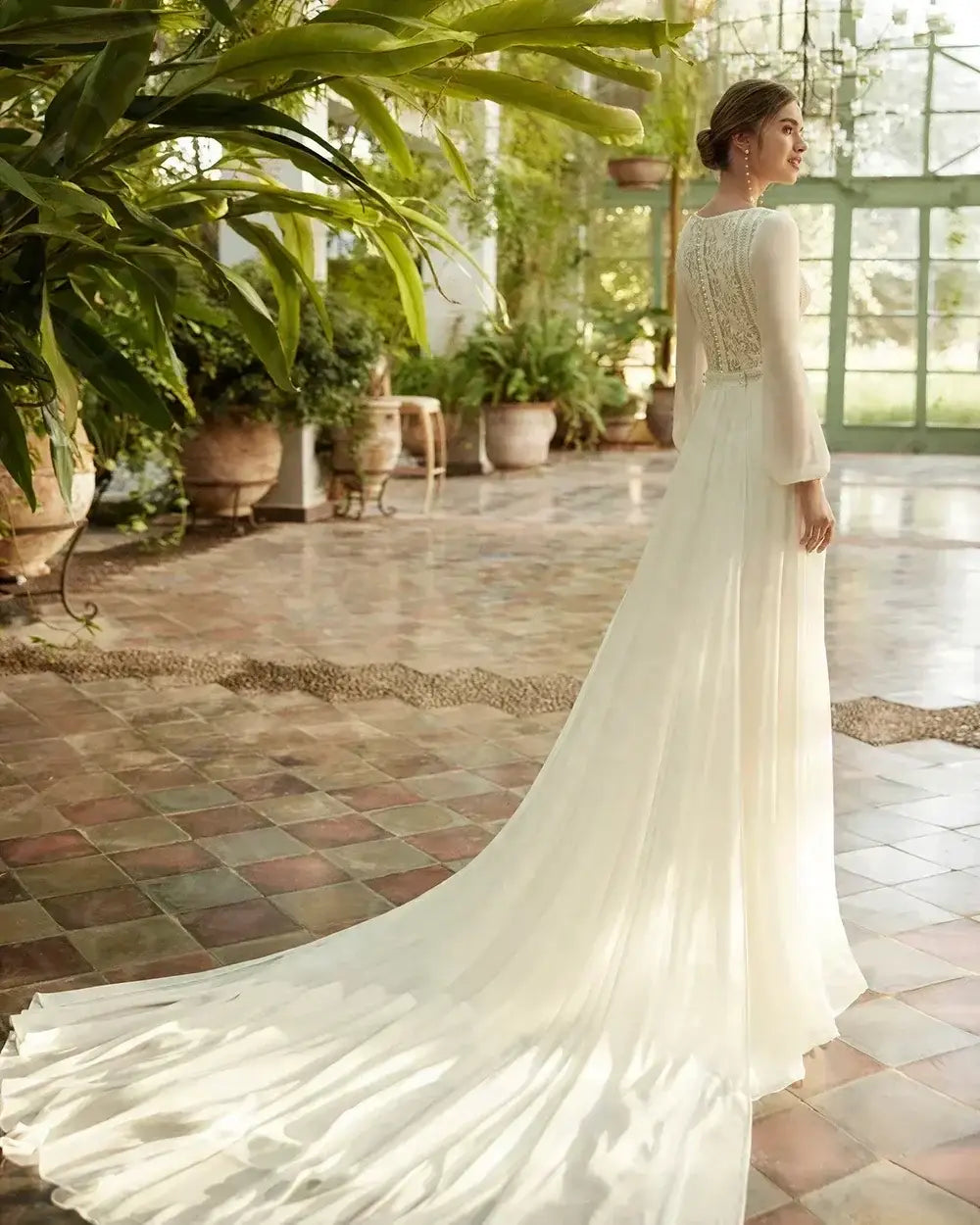 Beach Wedding Dress in white lace with long sleeves, intricate back detailing, and a flowing court train