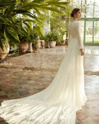 Beach Wedding Dress in white lace with long sleeves, intricate back detailing, and a flowing court train