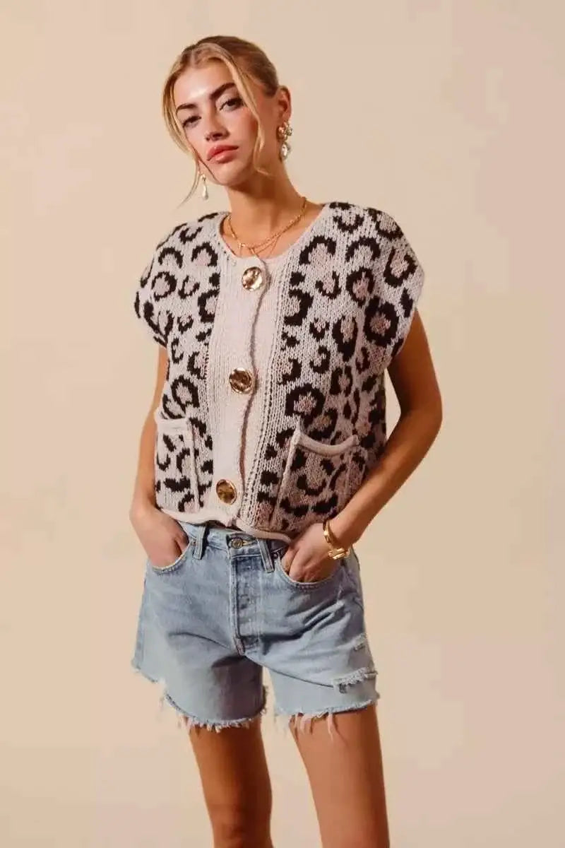 Sweater vest top featuring a beige and black leopard print knit with big metal button closures and front pockets