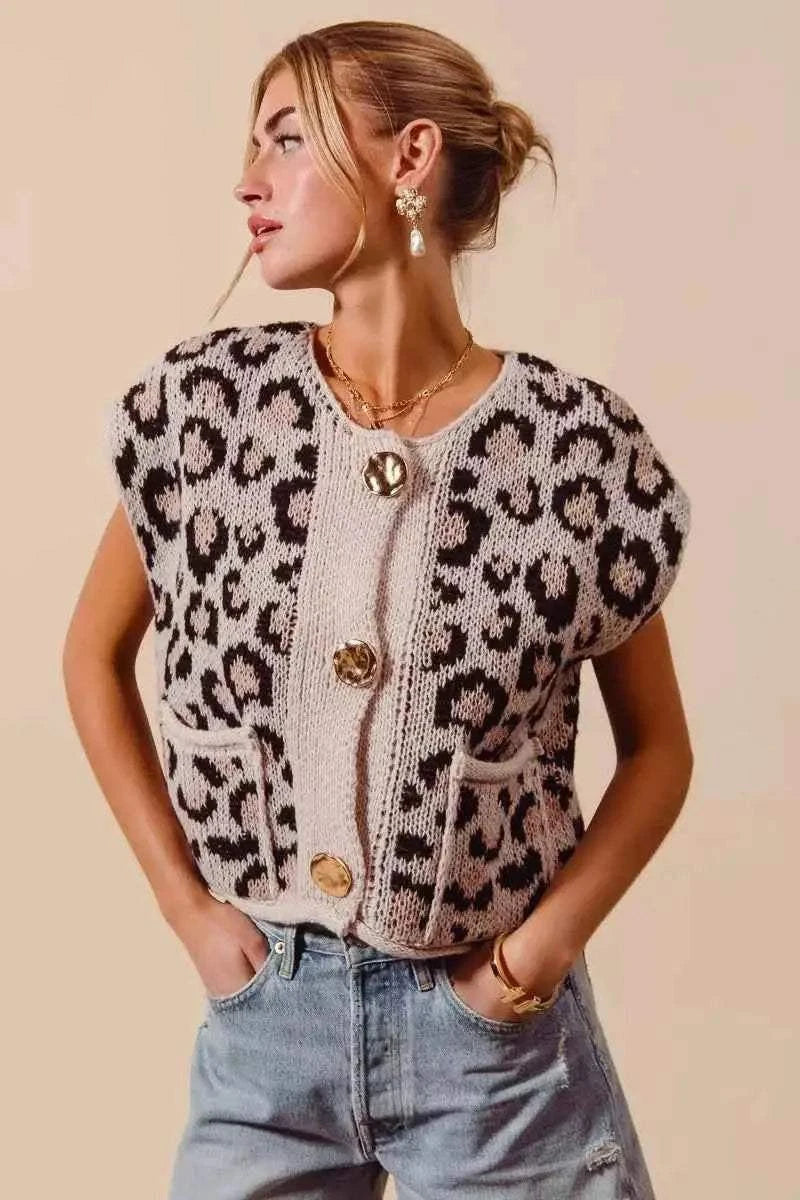 Leopard print sweater vest top with beige knit contrasting panel and three big metal button closures, worn with casual jeans