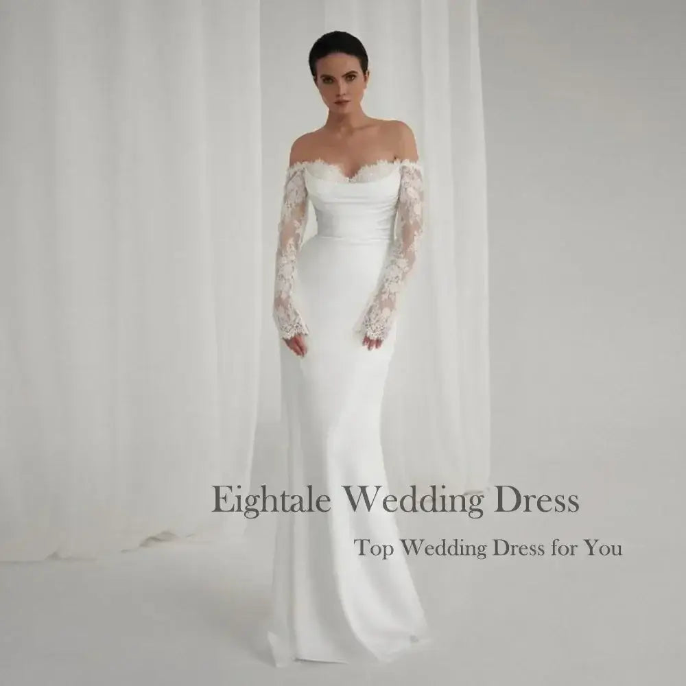 Bohemian Mermaid Wedding Dress in white with off-shoulder neckline, intricate lace sleeves, and elegant fitted silhouette