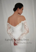 Bohemian Mermaid Wedding Dress in white lace with off-shoulder long sleeves and fitted silhouette from back view