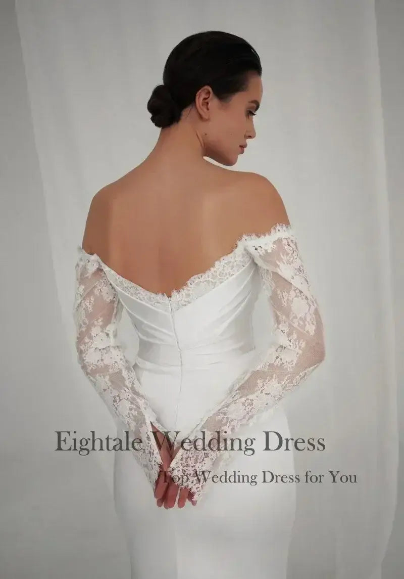 Bohemian Mermaid Wedding Dress in white lace with off-shoulder long sleeves and fitted silhouette from back view