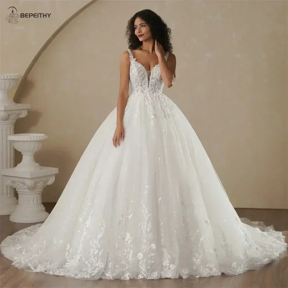 Boho Champagne Wedding Dress in ivory with intricate lace appliques, sleeveless strapless neckline, and flowing A-line silhouette