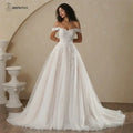 Boho Champagne Wedding Dress featuring an off-shoulder neckline, delicate lace appliques, and a flowing A-line skirt