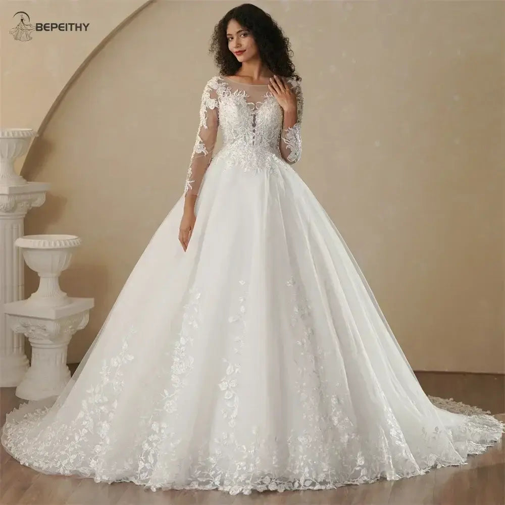 Boho Champagne Wedding Dress featuring a white A-line silhouette with long sheer lace sleeves and embroidered floral appliques