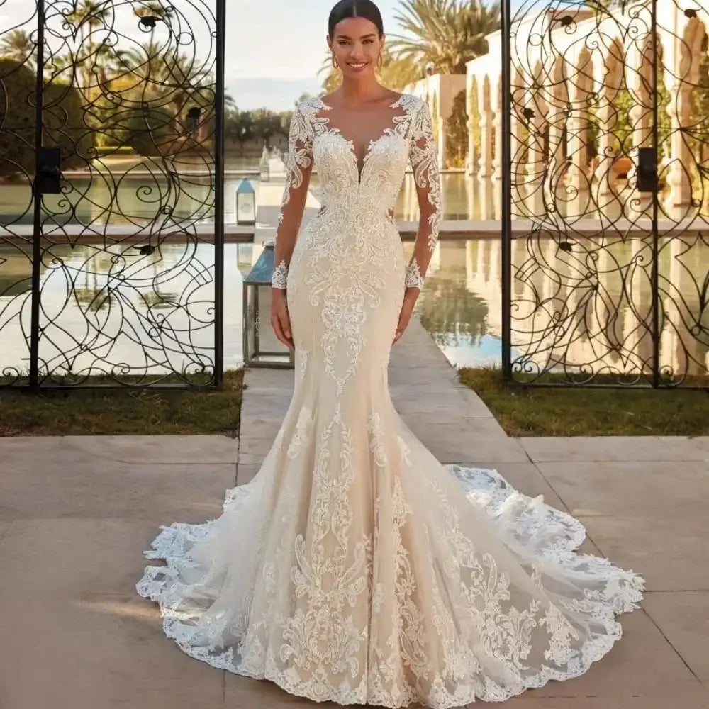 Boho Mermaid Wedding Dress in ivory with sheer long lace sleeves, intricate floral appliques, and a dramatic court train