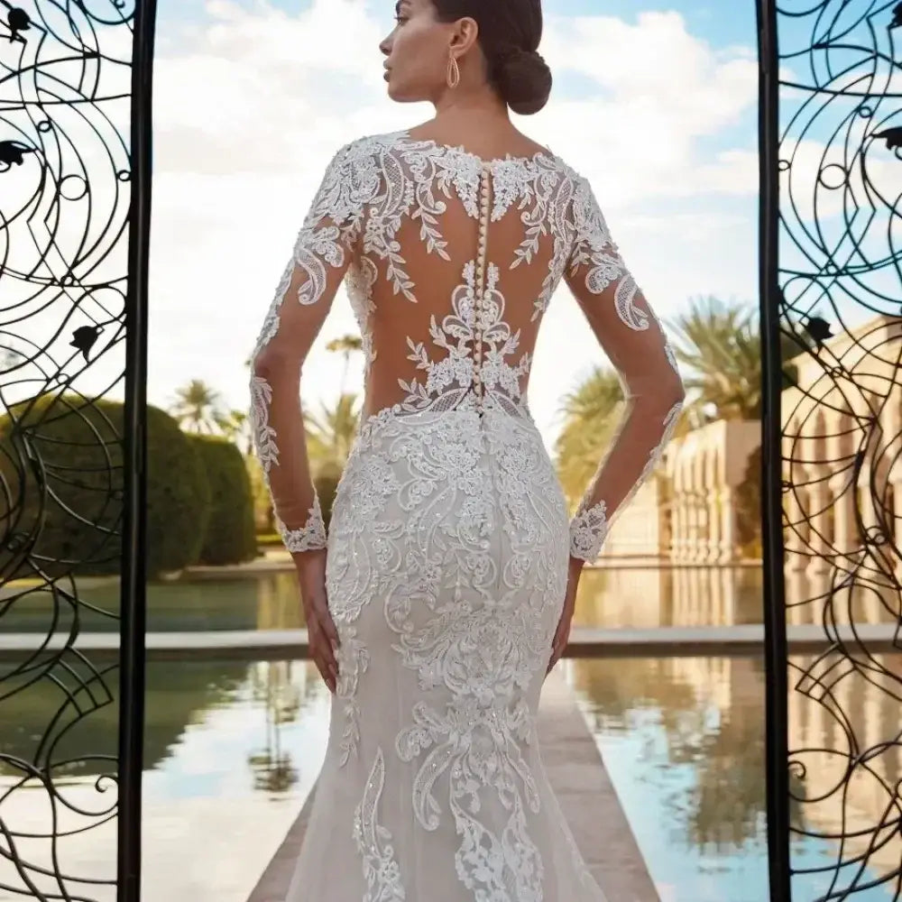 Boho Mermaid Wedding Dress featuring sheer long sleeves and intricate white lace appliques on a fitted silhouette with button-back closure