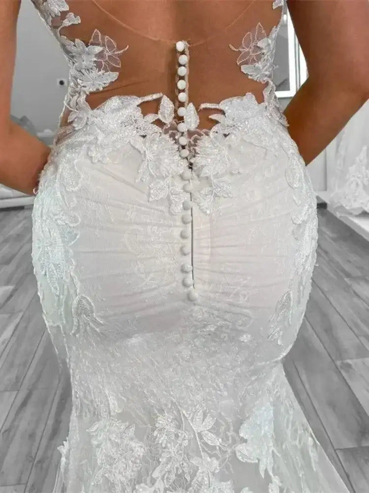 Boho Mermaid Wedding dress in white polyester tulle with lace appliques and button back closure on fitted silhouette