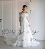 Elegant Lace Wedding Dress in ivory featuring off shoulder sweetheart neckline, full lace sleeves, and sweep train design