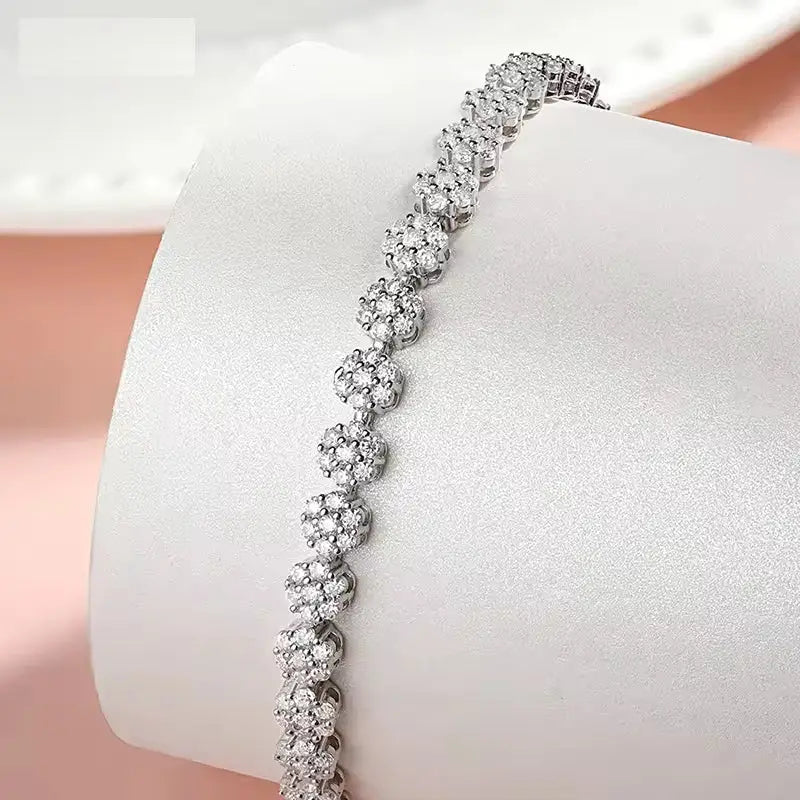 Brilliant Flower Created Moissanite Tennis Bracelet with sparkling flower-cut white stones set in 14K white gold overlay sterling silver