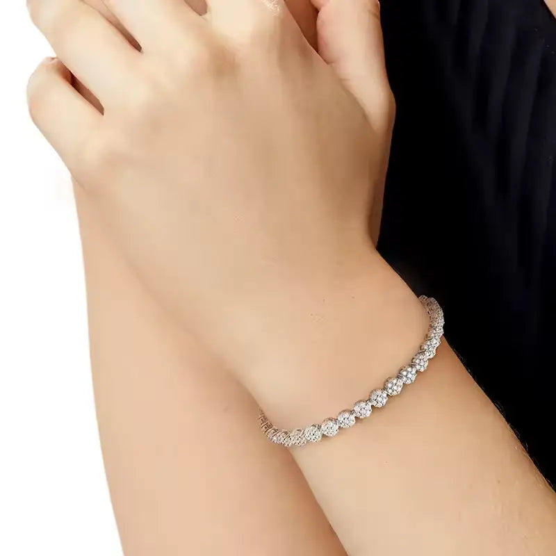 Brilliant Flower Created Moissanite Tennis Bracelet with round, sparkling white stones set in 14K white gold overlay on sterling silver
