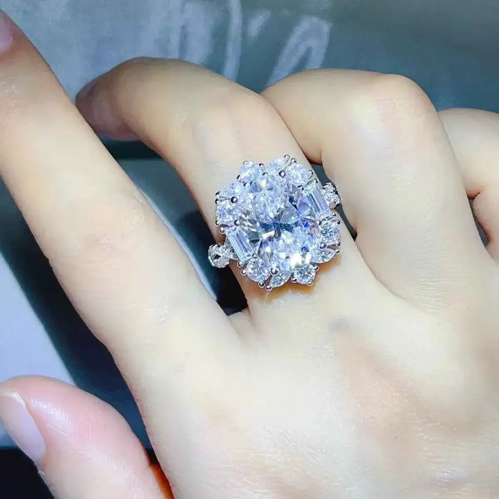 8 Carat 925 Sterling Silver ring featuring a large central moissanite stone surrounded by smaller stones in a floral cluster design.