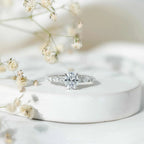 Carat IGI Certified Oval Diamond engagement ring with oval center stone and sparkling round side diamonds in a silver band